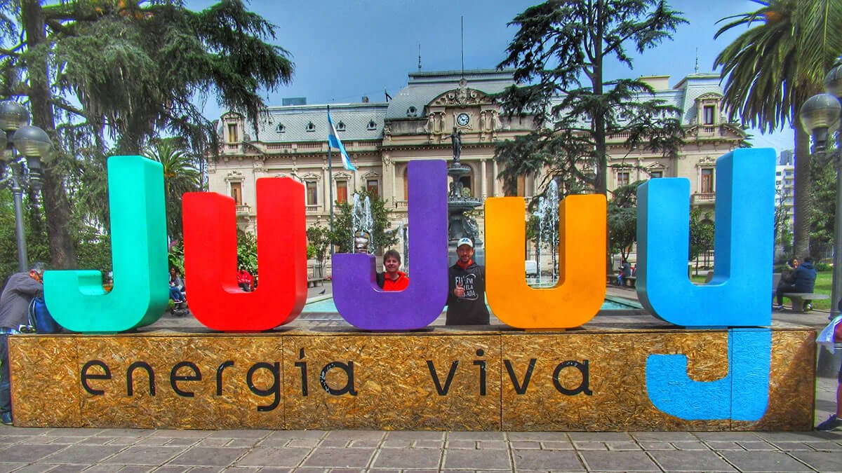 Letreiro de Jujuy na Plaza Belgrano, no centro de San Salvador de Jujuy, com a Casa de Gobierno de Jujuy ao fundo, em um dia ensolarado no Norte da Argentina.